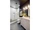 Chic bathroom with black accent wall, custom vanity, glass-enclosed shower and white tile details at 9322 E Hidden Green Dr, Scottsdale, AZ 85262