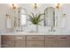 Bathroom featuring dual sinks, gold fixtures, and matching arched mirrors at 9322 E Hidden Green Dr, Scottsdale, AZ 85262