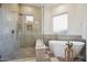 This bathroom is equipped with a shower, soaker tub, and a frosted window at 9322 E Hidden Green Dr, Scottsdale, AZ 85262