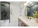 Elegant bathroom featuring a tiled shower, wooden vanity, and marble countertop at 9322 E Hidden Green Dr, Scottsdale, AZ 85262