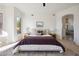 Relaxing primary bedroom features a stylish rug, modern lighting, and access to the bathroom at 9322 E Hidden Green Dr, Scottsdale, AZ 85262