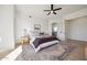 Spacious primary bedroom featuring a ceiling fan, bathroom access, and bright natural lighting at 9322 E Hidden Green Dr, Scottsdale, AZ 85262