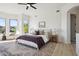 Bright bedroom boasts natural light, ceiling fan, and decoratively patterned area rug at 9322 E Hidden Green Dr, Scottsdale, AZ 85262