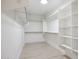 Walk-in closet with built-in shelving and hanging rods at 9322 E Hidden Green Dr, Scottsdale, AZ 85262