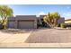 Attractive single-story home featuring a three-car garage and low-maintenance desert landscaping at 9322 E Hidden Green Dr, Scottsdale, AZ 85262
