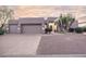 Contemporary home with a two-car garage and desert landscaping at 9322 E Hidden Green Dr, Scottsdale, AZ 85262