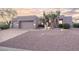 Contemporary home with desert landscaping and a two-car garage at 9322 E Hidden Green Dr, Scottsdale, AZ 85262