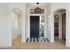 Bright foyer with black-and-white tile, a stylish pendant light, and arched entryways showcasing modern design elements at 9322 E Hidden Green Dr, Scottsdale, AZ 85262