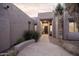 Charming home entrance featuring a stone walkway, desert landscaping, and a welcoming front door at 9322 E Hidden Green Dr, Scottsdale, AZ 85262