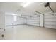 Spacious garage featuring epoxy floors, bright lighting, and ample storage space at 9322 E Hidden Green Dr, Scottsdale, AZ 85262