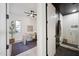 Modern home office with a natural light, a ceiling fan, a stylish desk and an adjacent elegant, tiled bathroom at 9322 E Hidden Green Dr, Scottsdale, AZ 85262