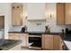 Modern kitchen with stainless steel appliances, wooden cabinets, and white backsplash at 9322 E Hidden Green Dr, Scottsdale, AZ 85262