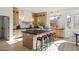 Bright kitchen featuring a large island with seating and plenty of natural light at 9322 E Hidden Green Dr, Scottsdale, AZ 85262