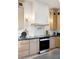 Well-lit kitchen featuring modern appliances, sleek countertops, and stylish wooden cabinetry at 9322 E Hidden Green Dr, Scottsdale, AZ 85262