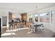 Bright kitchen features a center island with seating, updated appliances, and adjacent dining area at 9322 E Hidden Green Dr, Scottsdale, AZ 85262