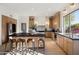 Open kitchen with a large island, modern appliances, and hardwood floors at 9322 E Hidden Green Dr, Scottsdale, AZ 85262
