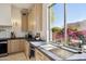 Well-lit kitchen featuring a sink with a view and modern fixtures at 9322 E Hidden Green Dr, Scottsdale, AZ 85262