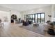 Spacious living area with an open floor plan, light wood floors and access to the backyard at 9322 E Hidden Green Dr, Scottsdale, AZ 85262