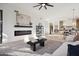Spacious living room with a fireplace, comfortable seating, and a smooth transition to the kitchen at 9322 E Hidden Green Dr, Scottsdale, AZ 85262