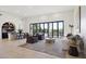 Bright and spacious living room with hardwood floors, neutral tones, and access to the backyard at 9322 E Hidden Green Dr, Scottsdale, AZ 85262