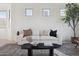 Bright living room featuring a comfortable couch and oversized windows at 9322 E Hidden Green Dr, Scottsdale, AZ 85262