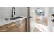 Close up of modern mud room, featuring marble countertop and sink at 9322 E Hidden Green Dr, Scottsdale, AZ 85262