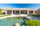 Beautiful backyard swimming pool and outdoor seating area with lush landscaping at 9322 E Hidden Green Dr, Scottsdale, AZ 85262