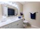 Well-lit bathroom with neutral-toned walls, large framed mirror, and decorative faucets and hardware at 9745 N 95Th St # 227, Scottsdale, AZ 85258
