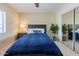Comfortable bedroom with a queen bed and large window; closet with mirrored doors to maximize light at 9745 N 95Th St # 227, Scottsdale, AZ 85258