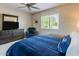 Comfortable bedroom featuring a large dresser with TV, and large window for an abundance of natural light at 9745 N 95Th St # 227, Scottsdale, AZ 85258