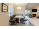 Dining nook with bench seating, modern lighting, and view into the living room at 9745 N 95Th St # 227, Scottsdale, AZ 85258