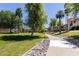 Manicured landscaping with mature trees along a walking path at 9745 N 95Th St # 227, Scottsdale, AZ 85258