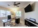 Bright home office with a ceiling fan, large desk, and piano at 9745 N 95Th St # 227, Scottsdale, AZ 85258