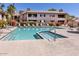 Community pool and hot tub with lounge seating and lush landscaping at 9745 N 95Th St # 227, Scottsdale, AZ 85258