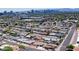 Expansive aerial view of a neighborhood featuring well-maintained homes with city skyline in the background at 1011 W Weldon Ave, Phoenix, AZ 85013