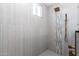 Shower area with a rain shower head and neutral-toned tiling at 1011 W Weldon Ave, Phoenix, AZ 85013
