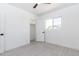 Bright bedroom features a ceiling fan, tiled floor, window and closet with white walls at 1011 W Weldon Ave, Phoenix, AZ 85013