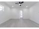 Spacious bedroom boasts a ceiling fan, neutral tiled floor and abundant natural light at 1011 W Weldon Ave, Phoenix, AZ 85013