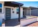 Close-up of home entrance, showcasing a modern front door, brick accents, and desert landscaping at 1011 W Weldon Ave, Phoenix, AZ 85013