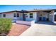 Inviting front exterior featuring desert landscaping, modern door, and covered parking at 1011 W Weldon Ave, Phoenix, AZ 85013