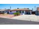 Charming single-story home with a spacious driveway, well-maintained lawn, and desert landscaping at 1011 W Weldon Ave, Phoenix, AZ 85013