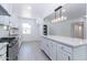 Bright kitchen featuring white cabinets, stainless steel appliances, and an elegant countertop at 1011 W Weldon Ave, Phoenix, AZ 85013
