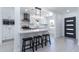 Modern kitchen with white cabinets, stainless steel appliances, and a stylish island with seating at 1011 W Weldon Ave, Phoenix, AZ 85013