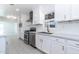Updated kitchen with white cabinets, stainless steel appliances, and a modern faucet at 1011 W Weldon Ave, Phoenix, AZ 85013