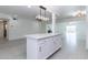 Open living area with white island, tile floors and modern lighting fixtures at 1011 W Weldon Ave, Phoenix, AZ 85013