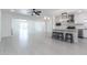 Spacious open-concept living area with tile flooring, modern lighting, and a kitchen island at 1011 W Weldon Ave, Phoenix, AZ 85013