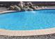 Inviting pool with rock waterfall feature, creating a relaxing backyard oasis at 1011 W Weldon Ave, Phoenix, AZ 85013