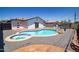 Backyard featuring a kidney-shaped pool with an attached spa and modern white-painted home at 1011 W Weldon Ave, Phoenix, AZ 85013