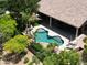 Aerial view highlighting the pool, covered patio, mature trees, and lush greenery of this private estate at 1092 N Roosevelt Ave, Chandler, AZ 85226