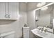 Cozy powder room with white fixtures, decorative lighting, and a corner cabinet at 1092 N Roosevelt Ave, Chandler, AZ 85226